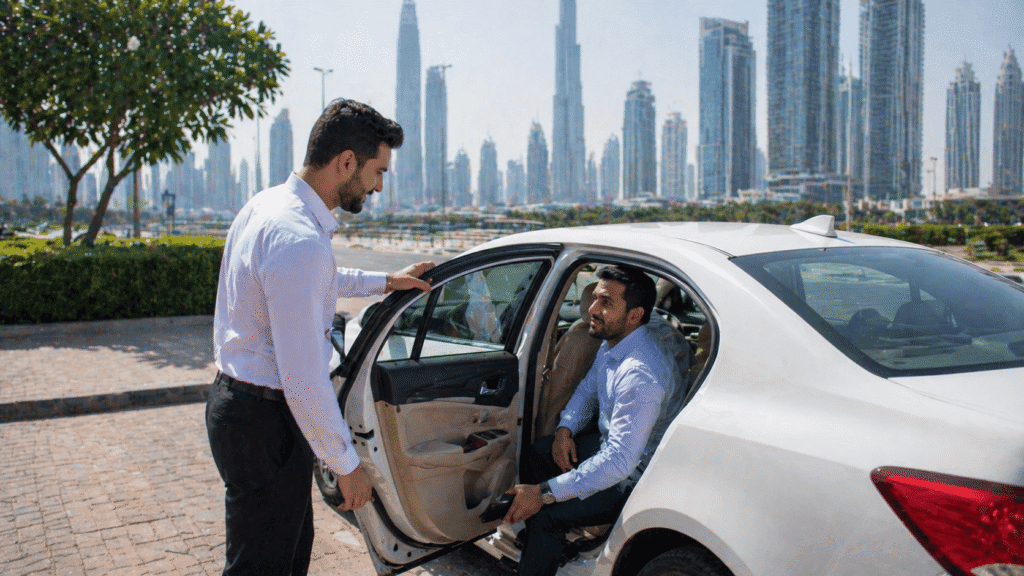 A professional driver assisting a passenger into a comfortable car in Dubai, representing a reliable monthly car lift Dubai service for daily commuting across the city